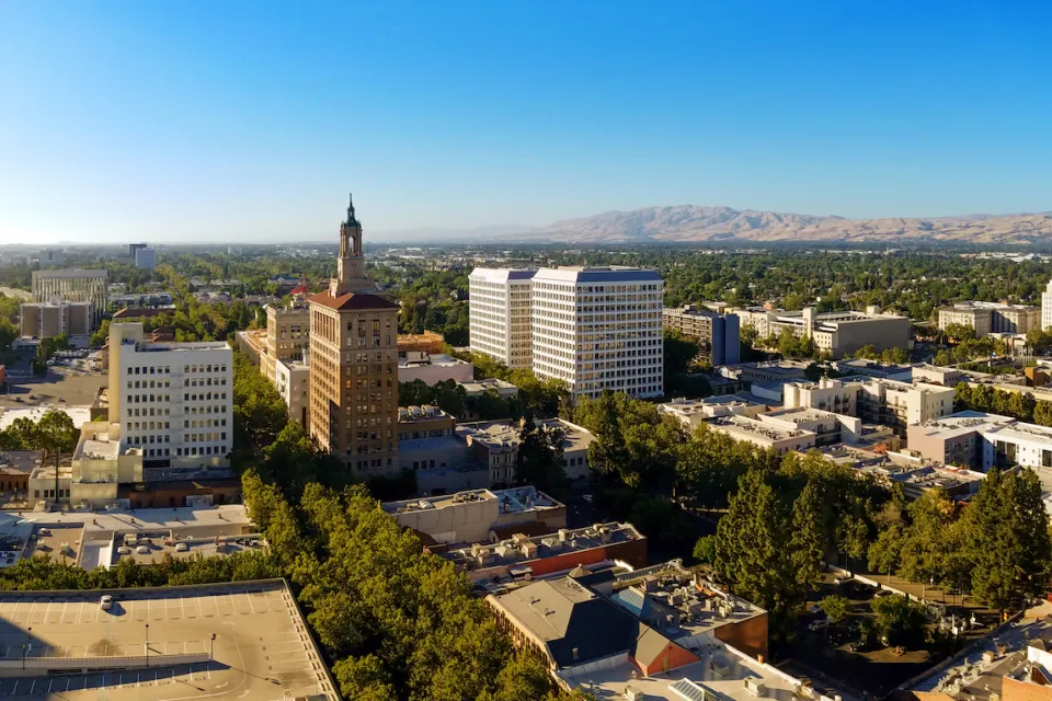 Aerial view of San Jose, California with mountains in background.